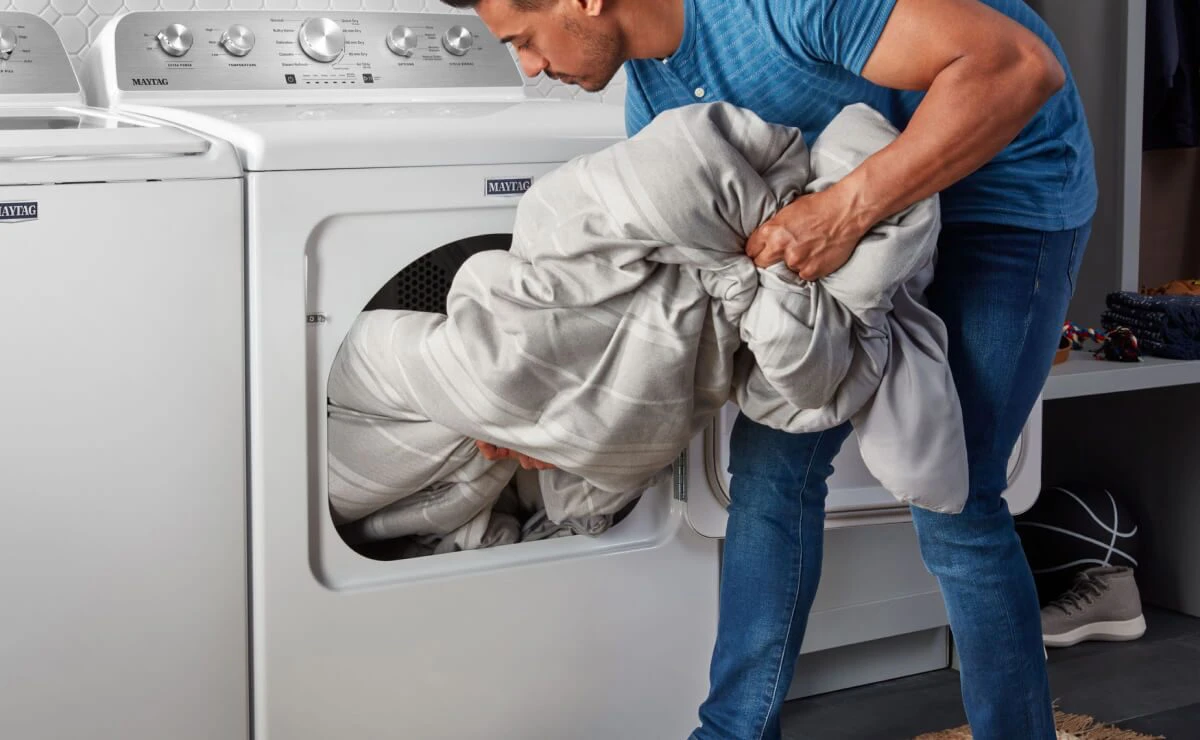 man using his dryer for sheets