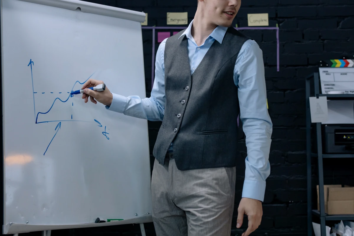 man writing with blue erase marker on white board
