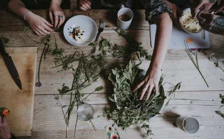 person touching a plate of herbs