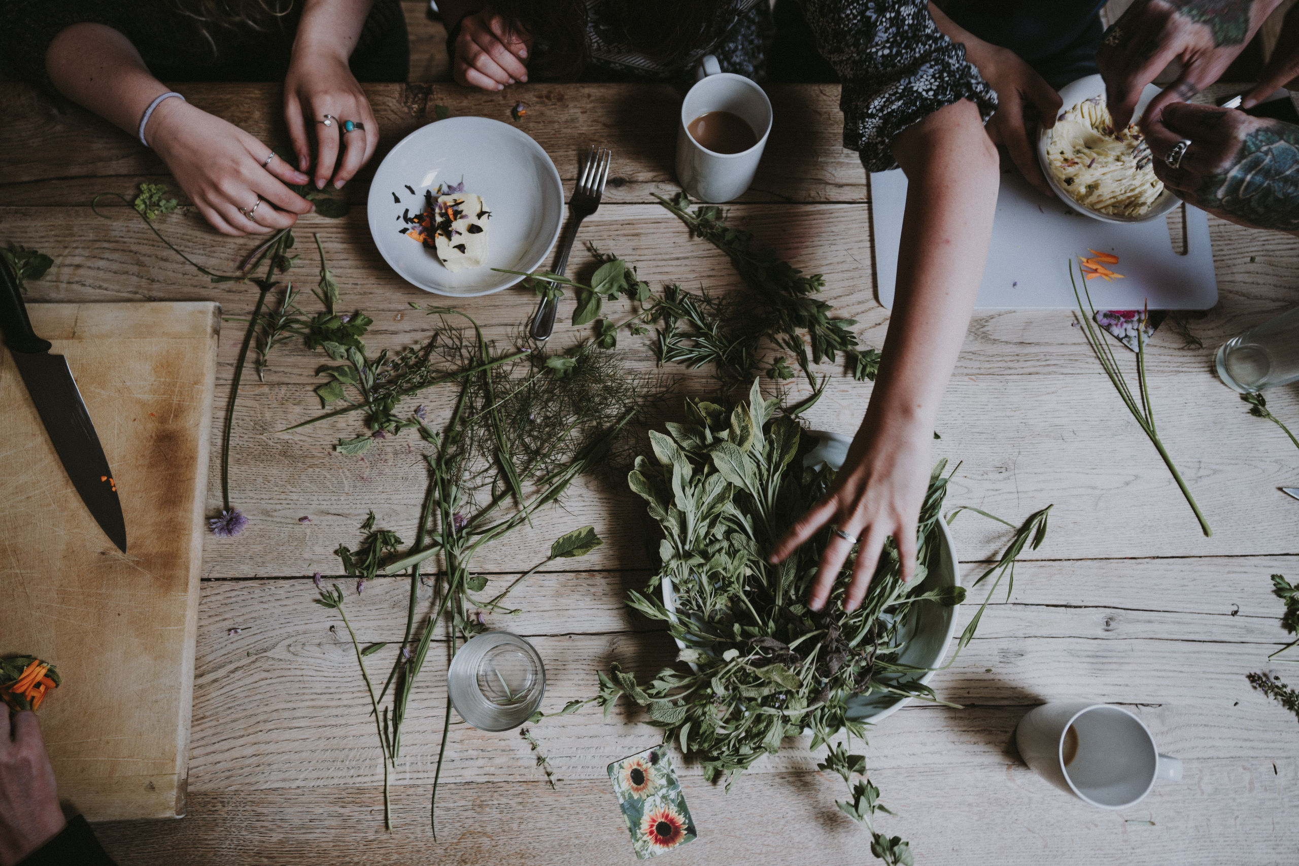 person touching a plate of herbs