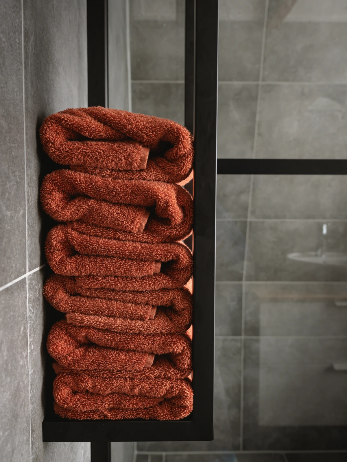 red towels in a stack in bathroom