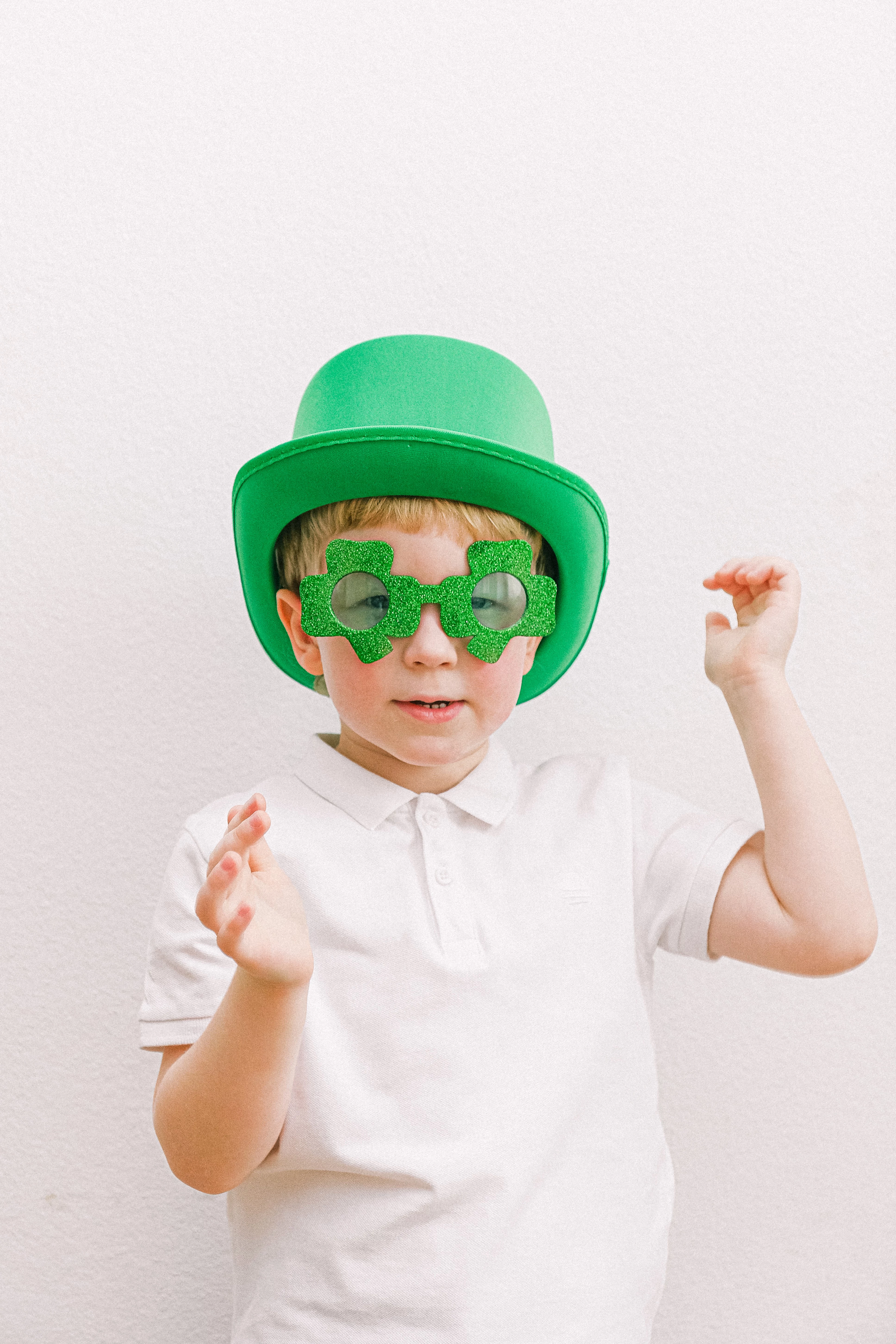 small boy with green hat and shamrock glasses