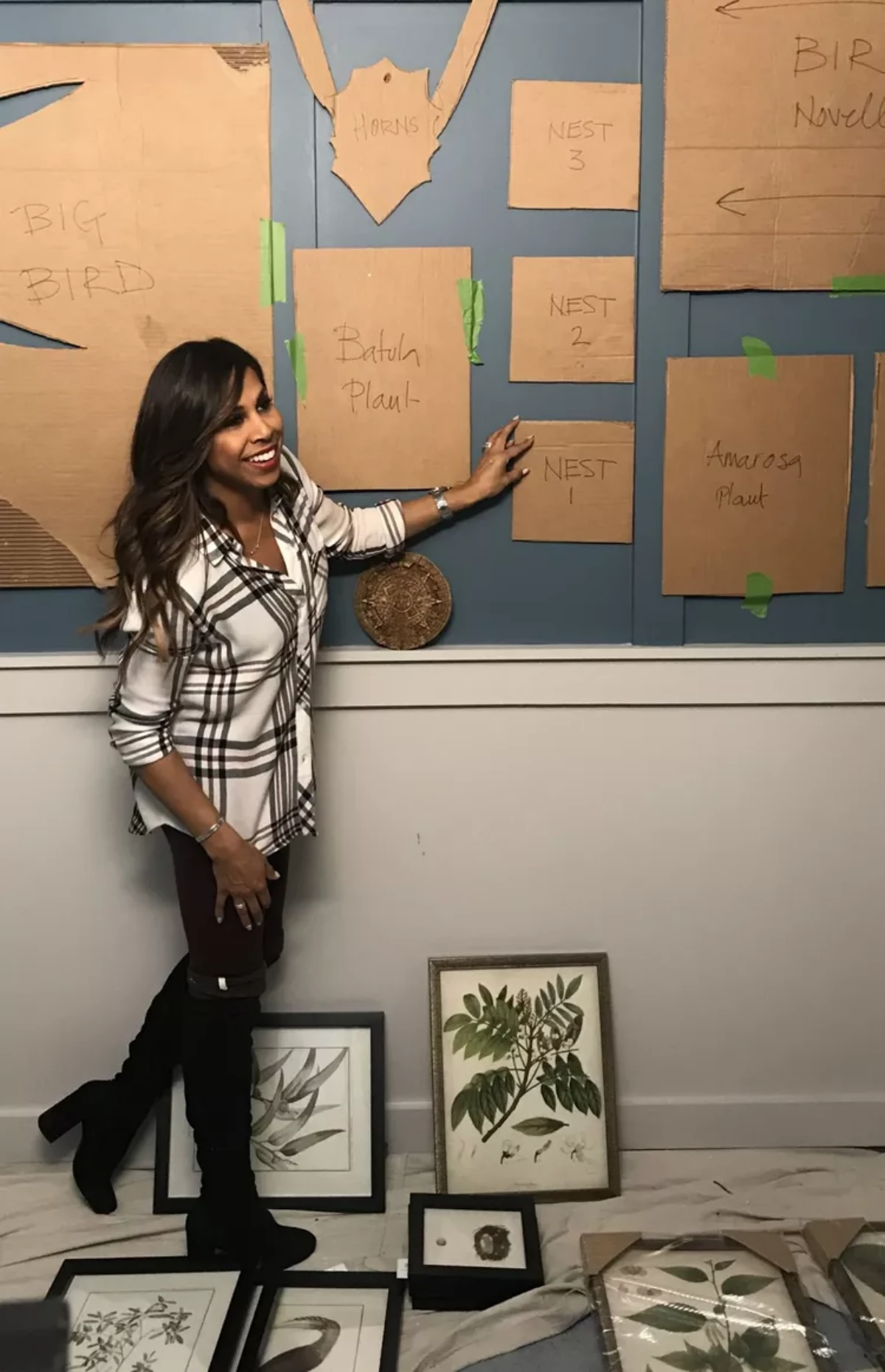 woman planning out her gallery wall