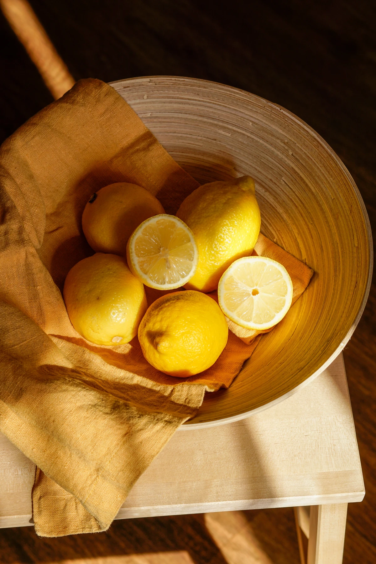 wooden bowl full of lemons