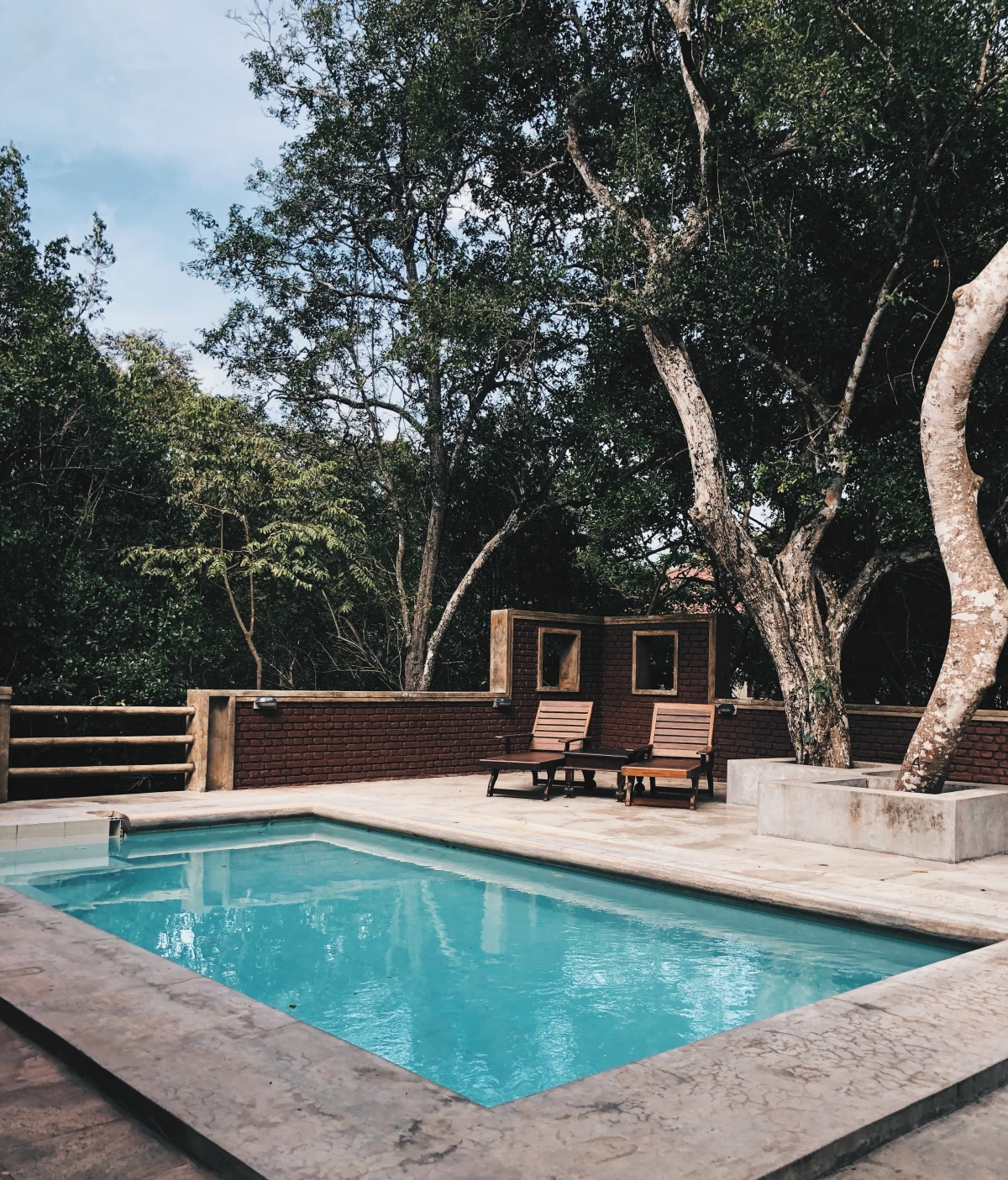 backyard swimming pool with chairs