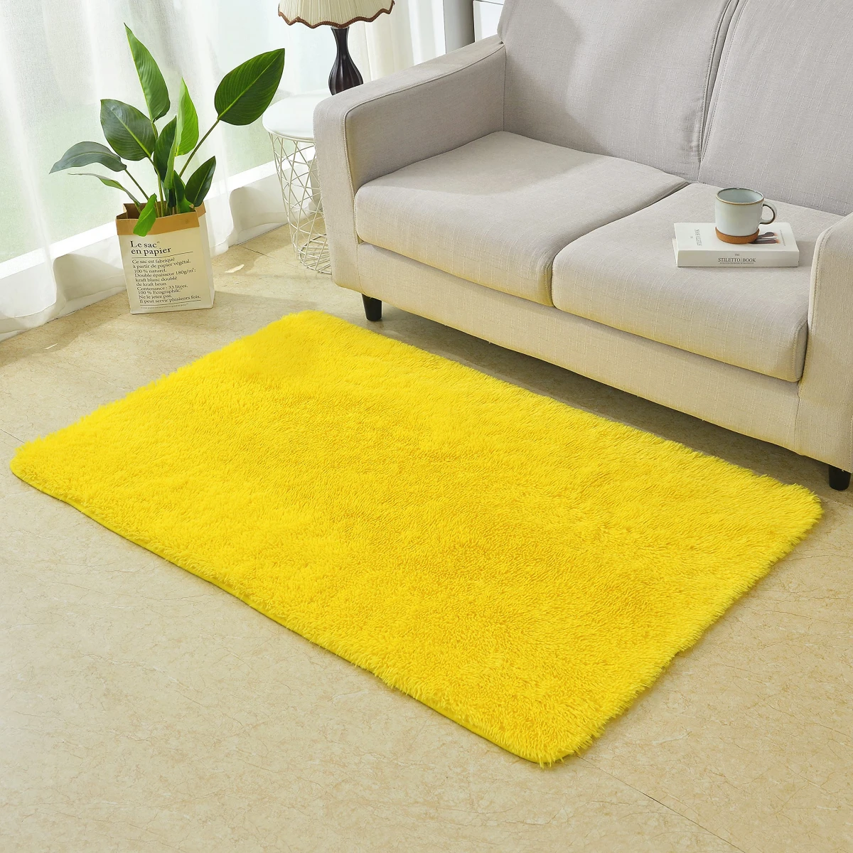 bright yellow rug in front of sofa
