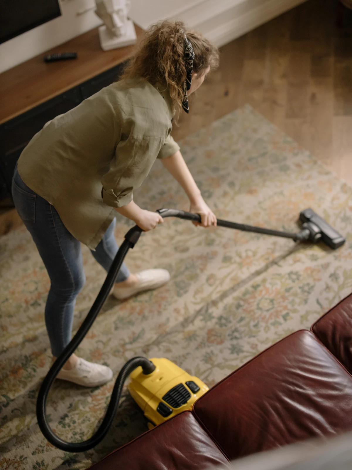 how to get rid of carpet beetles woman vacuuming her carpet