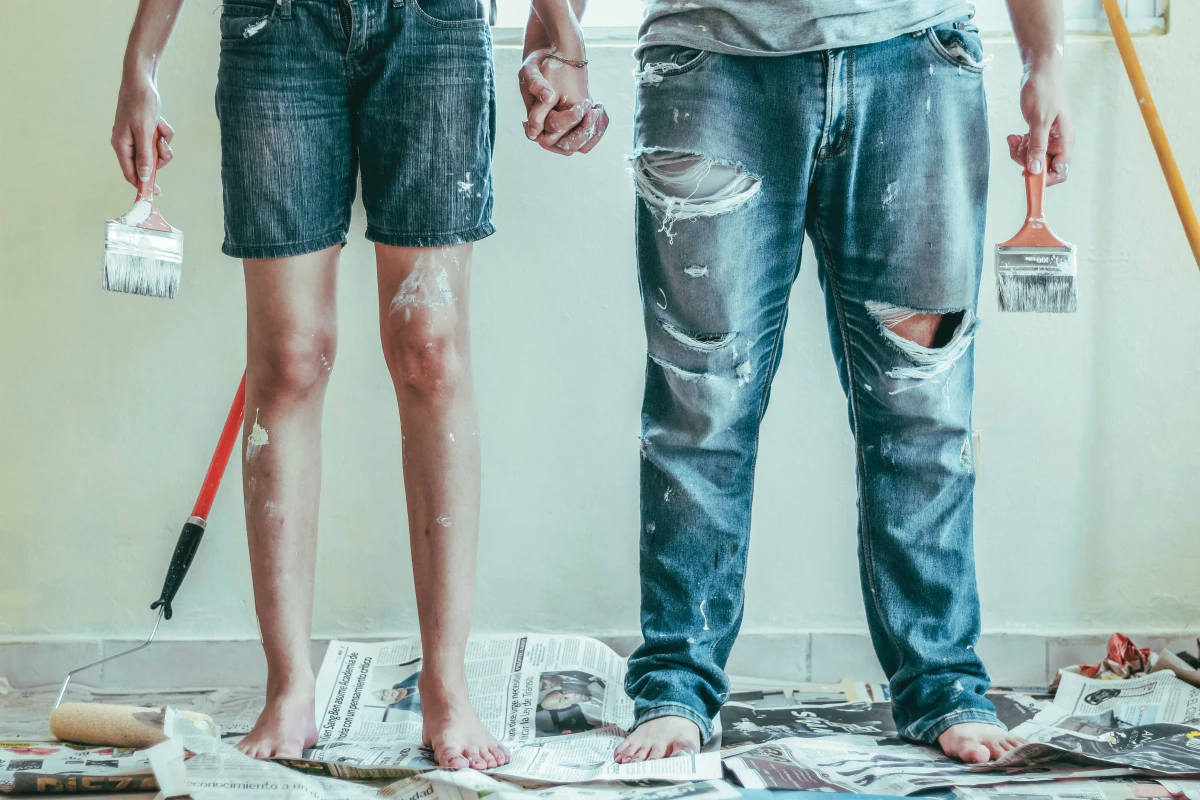man and woman holding hands covered in paint