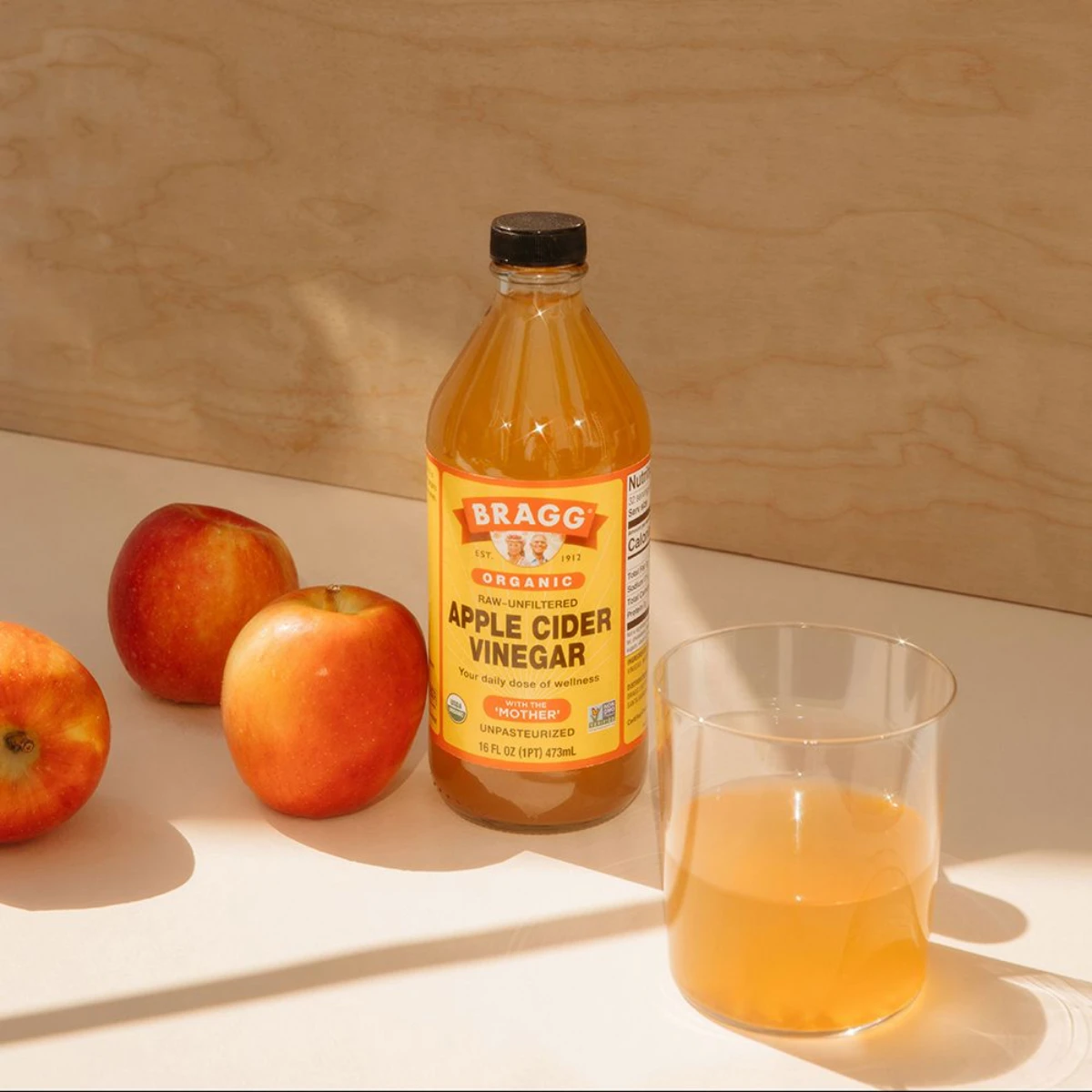 apple cider vinegar in a bottle and glass