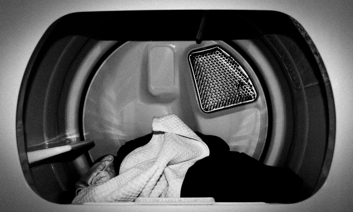 black and white dryer filled with clothes