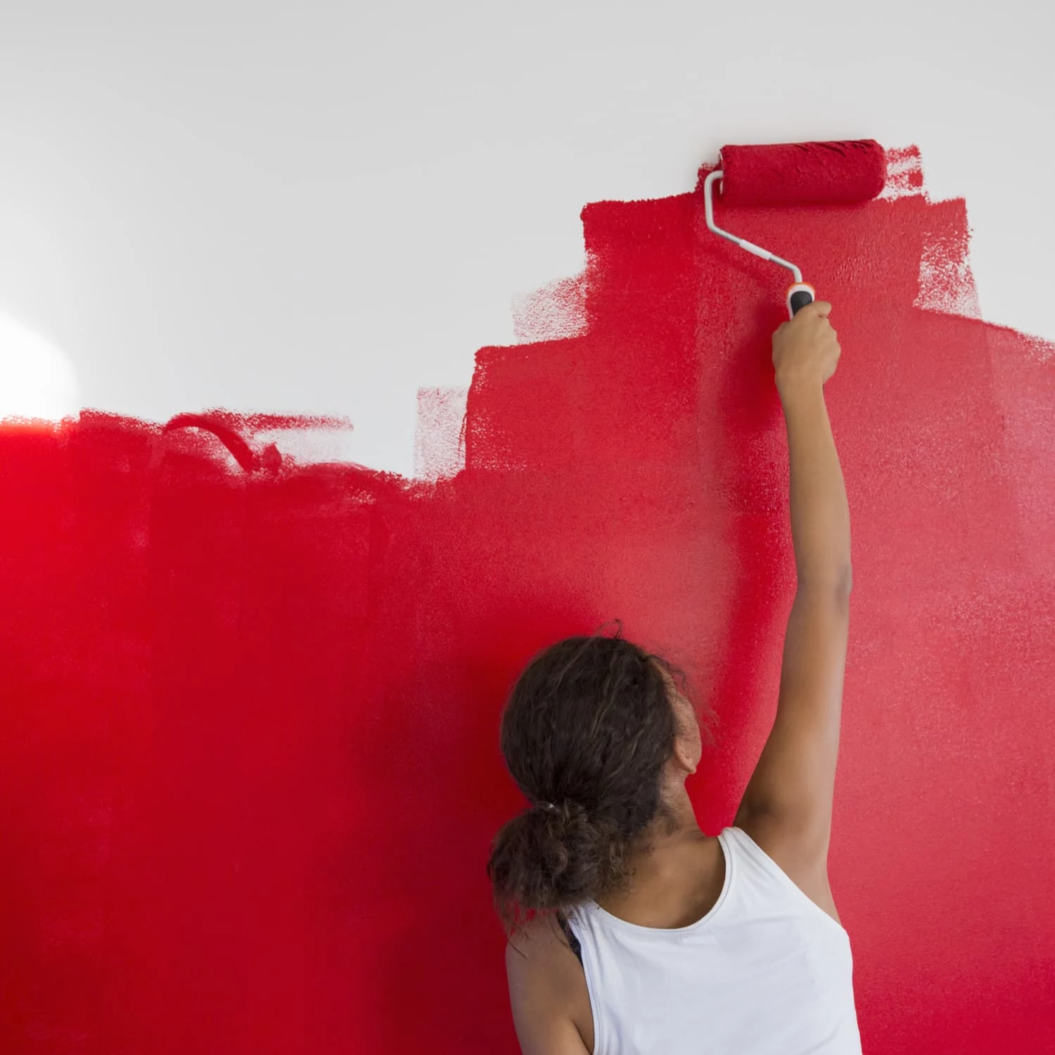 how to make paint dry faster woman painting a wall bright red