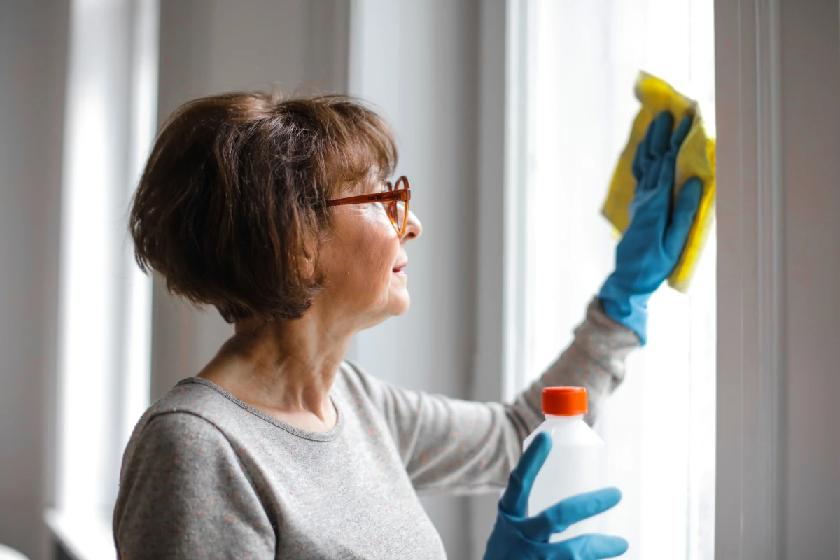 older woman cleaning windows