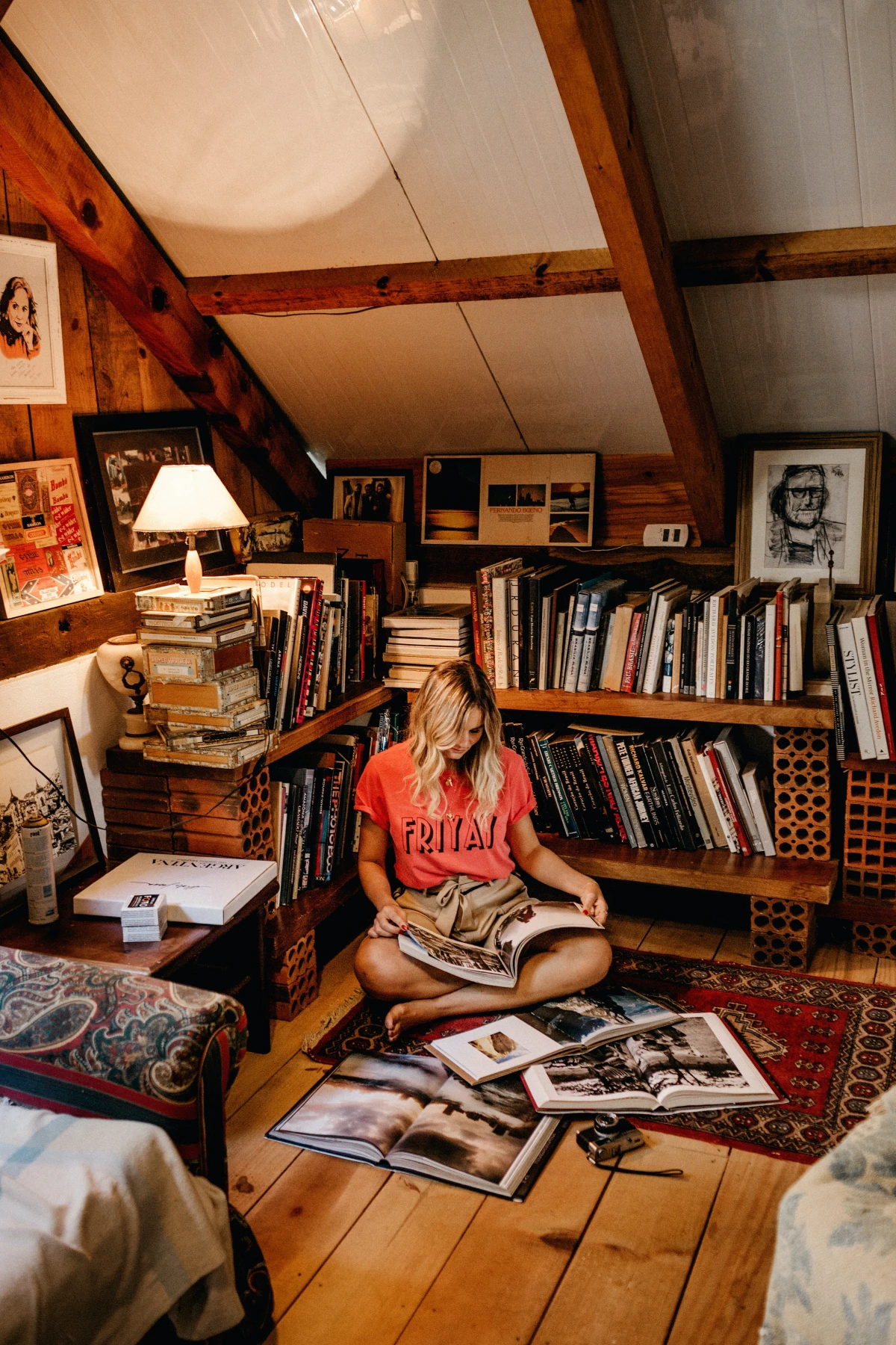 woman reading in between clutter of books