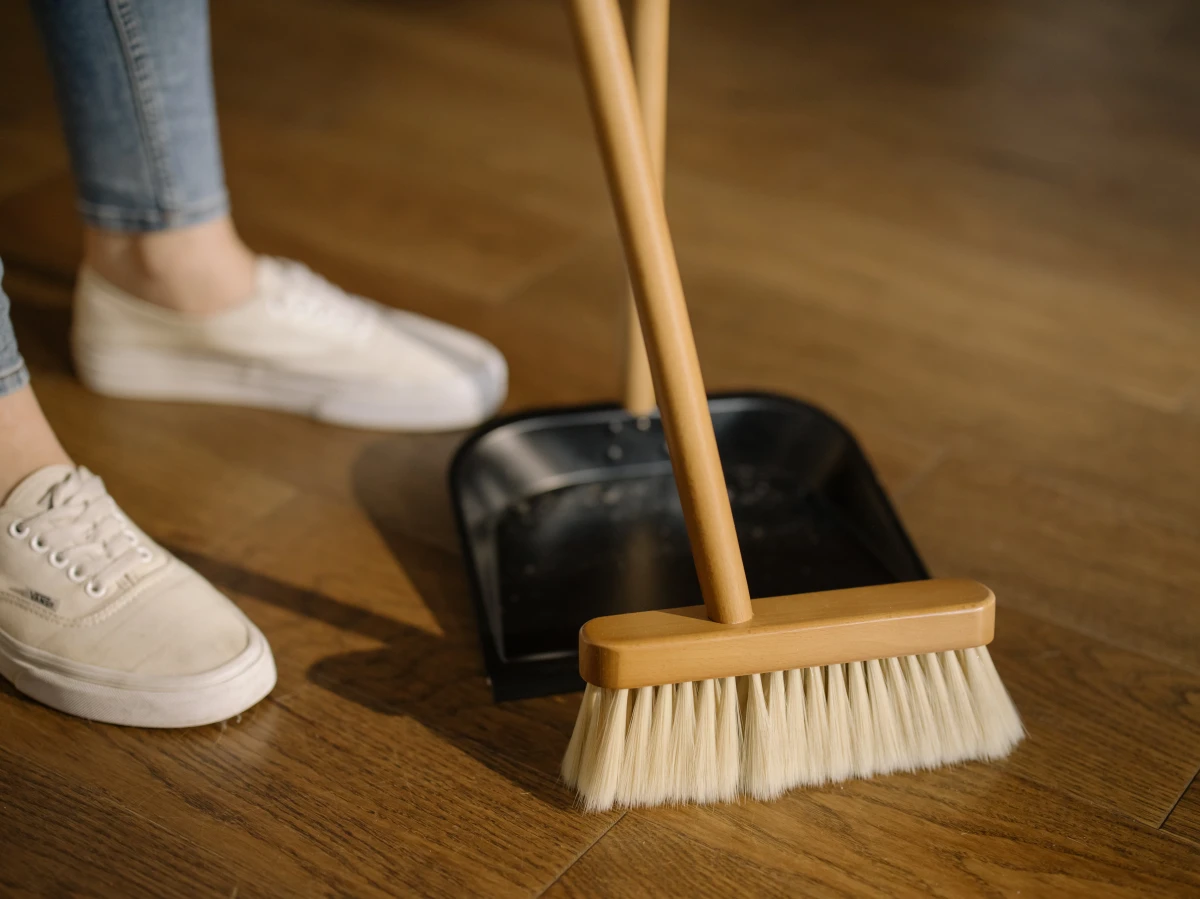 woman sweeping the floor