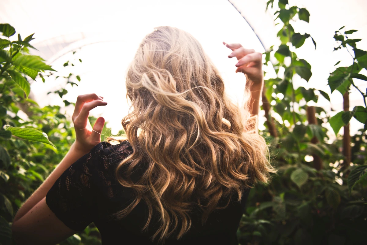 woman with blonde hair in garden