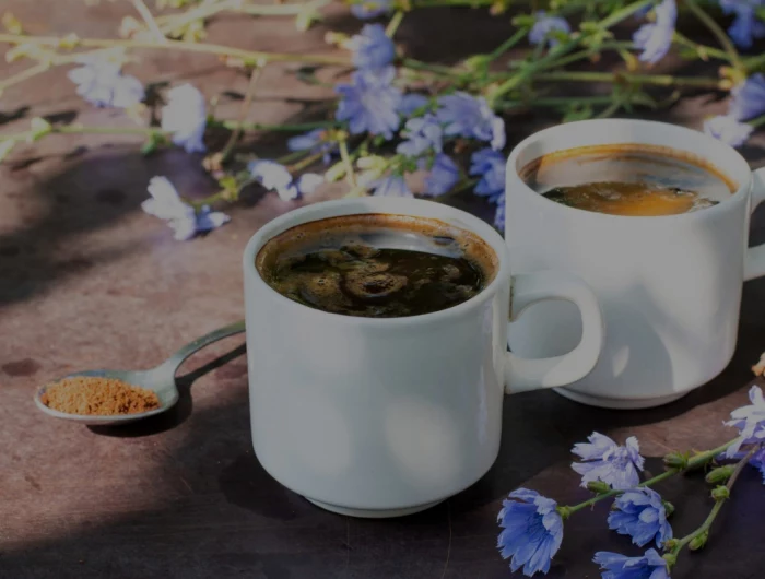 alternatives to coffee two cups of coffee and purple flowers