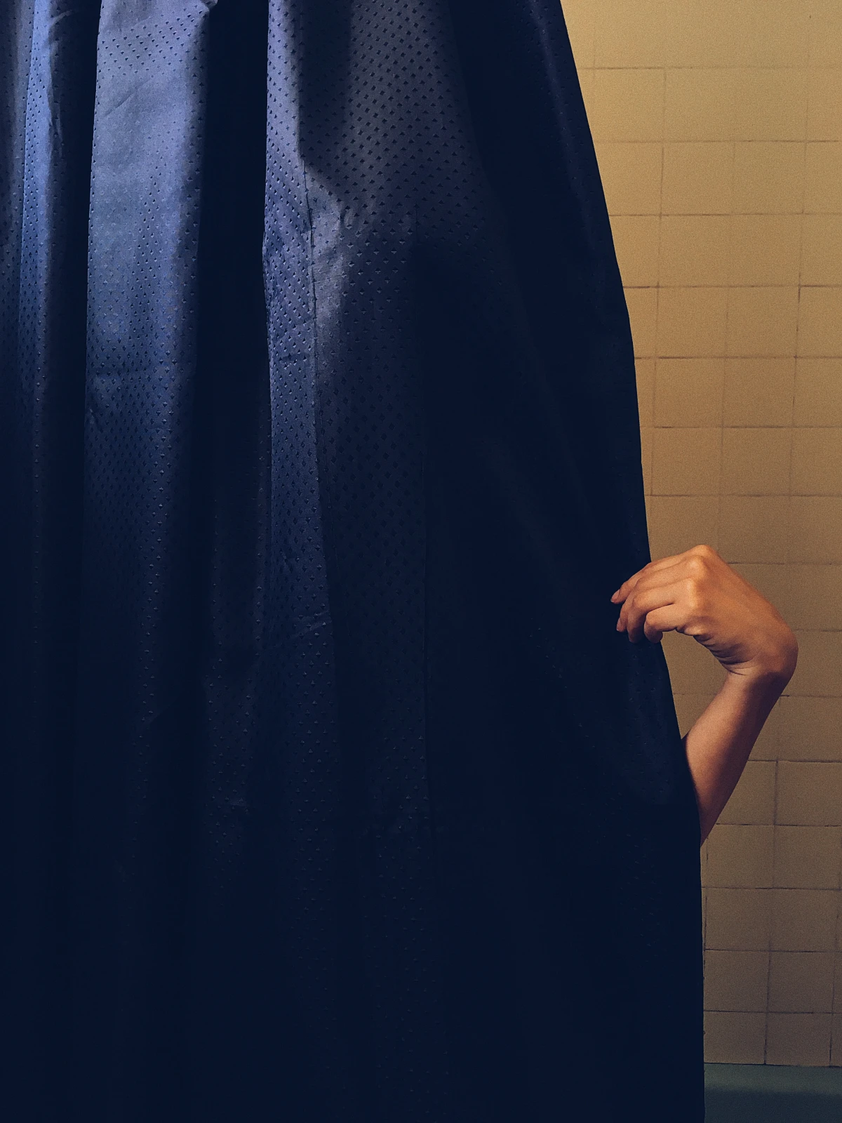 benefits of cold showers hand holding shower curtain