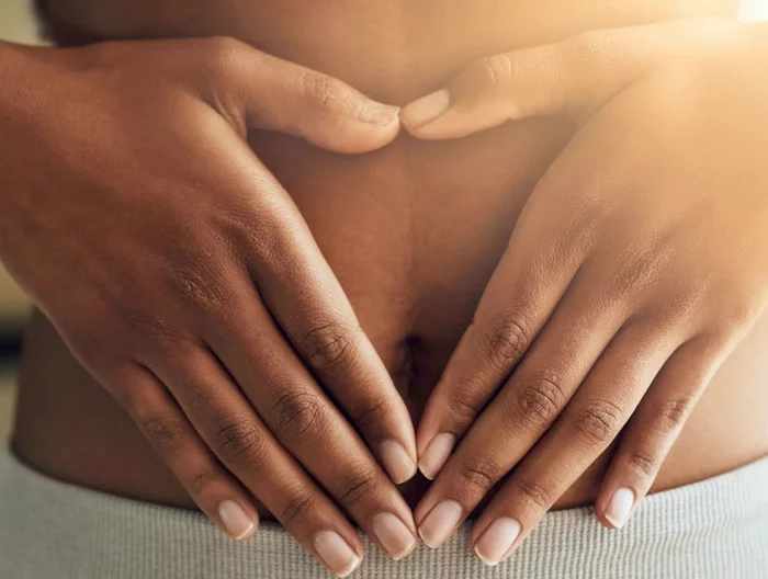 how to heal your gut person holding stomach