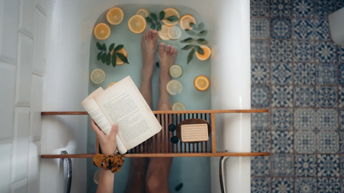 how to relieve stress person taking a bath with a book