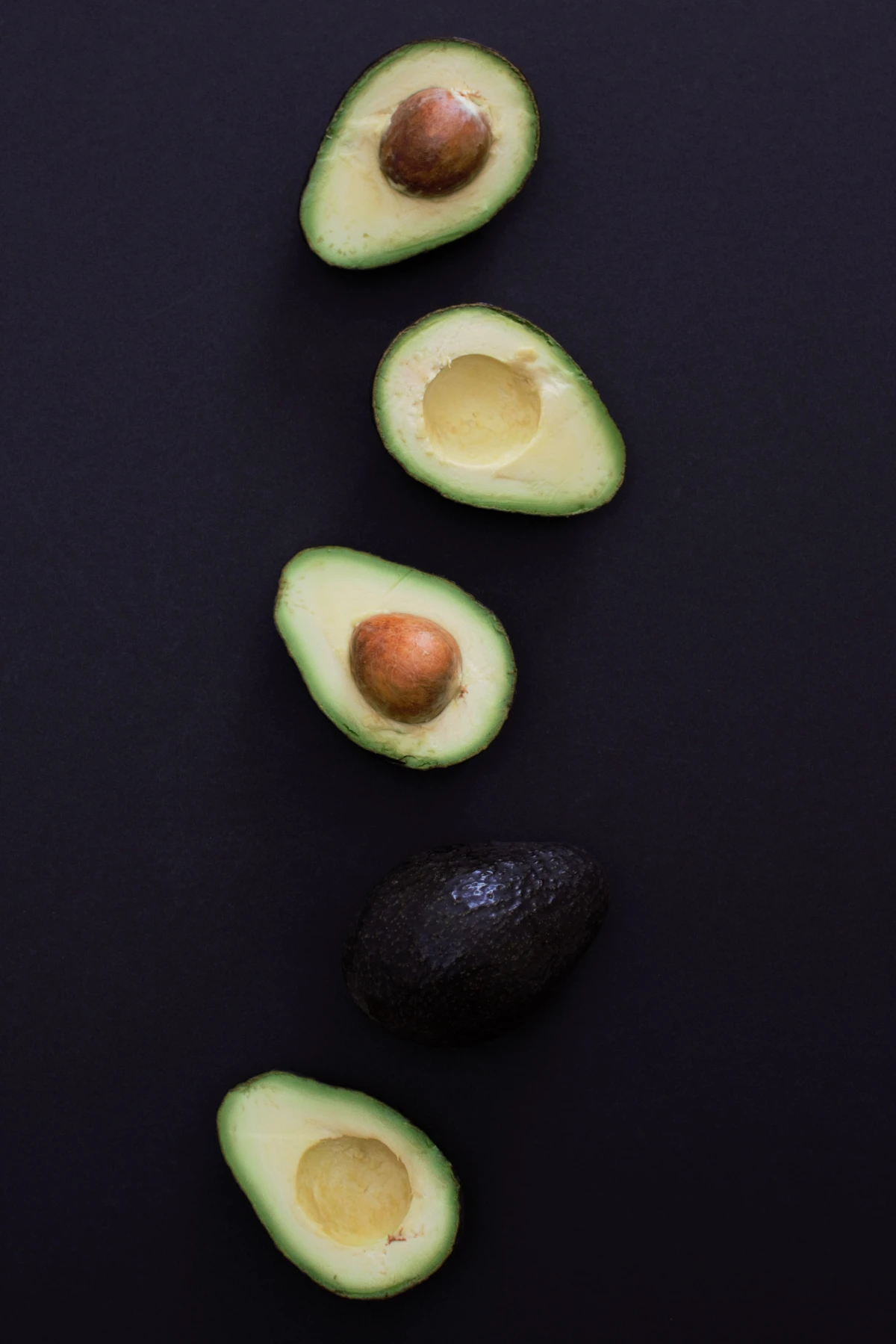mix of avocados on black background