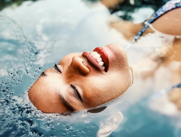 summer skincare woman in the water face floating