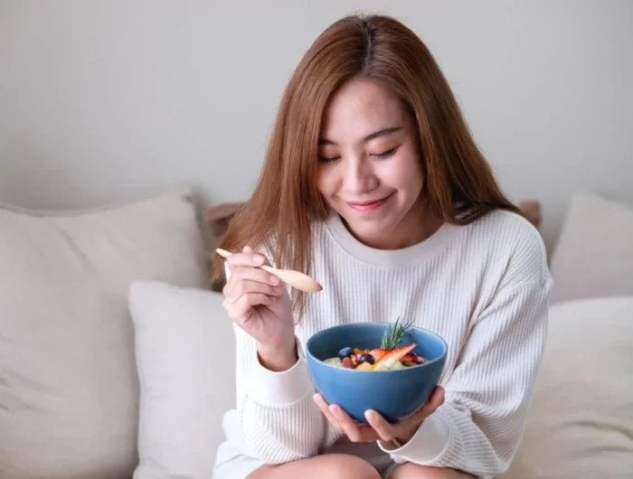 woman eating a bowl of yogurt