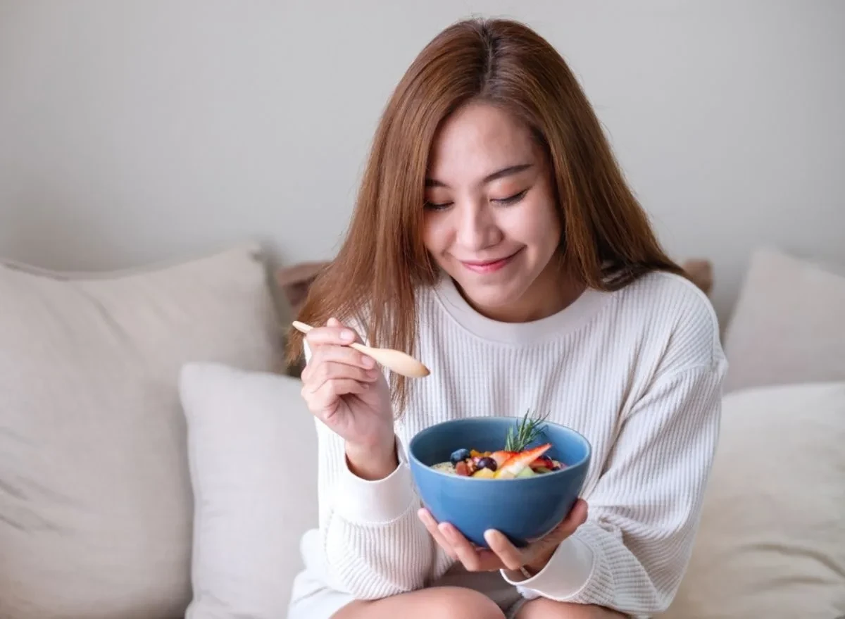 woman eating a bowl of yogurt