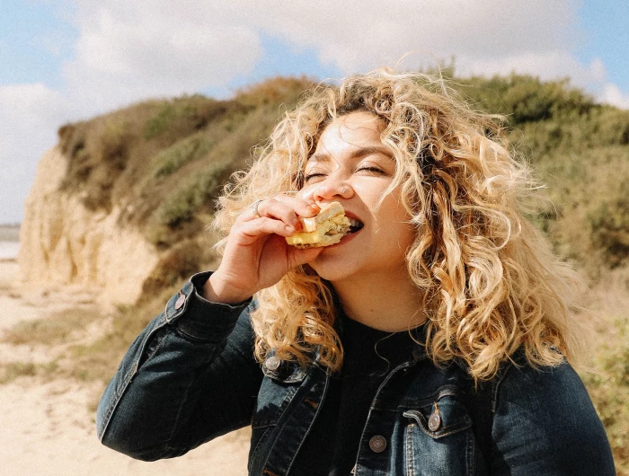 woman happily eating food