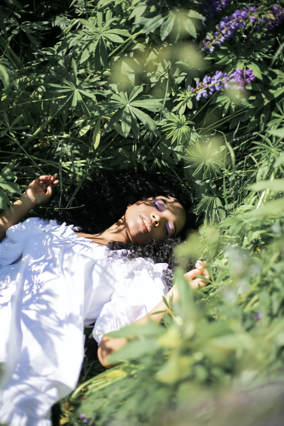 woman laying in grass sunbathing