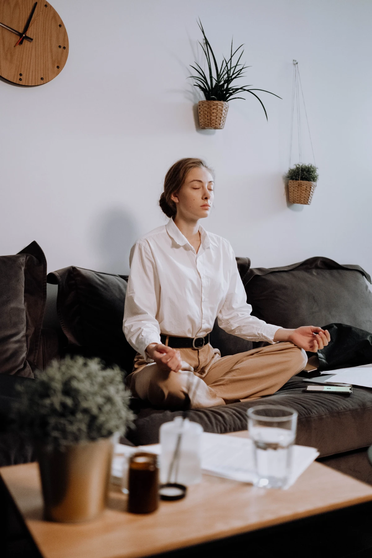 woman meditating on her couch