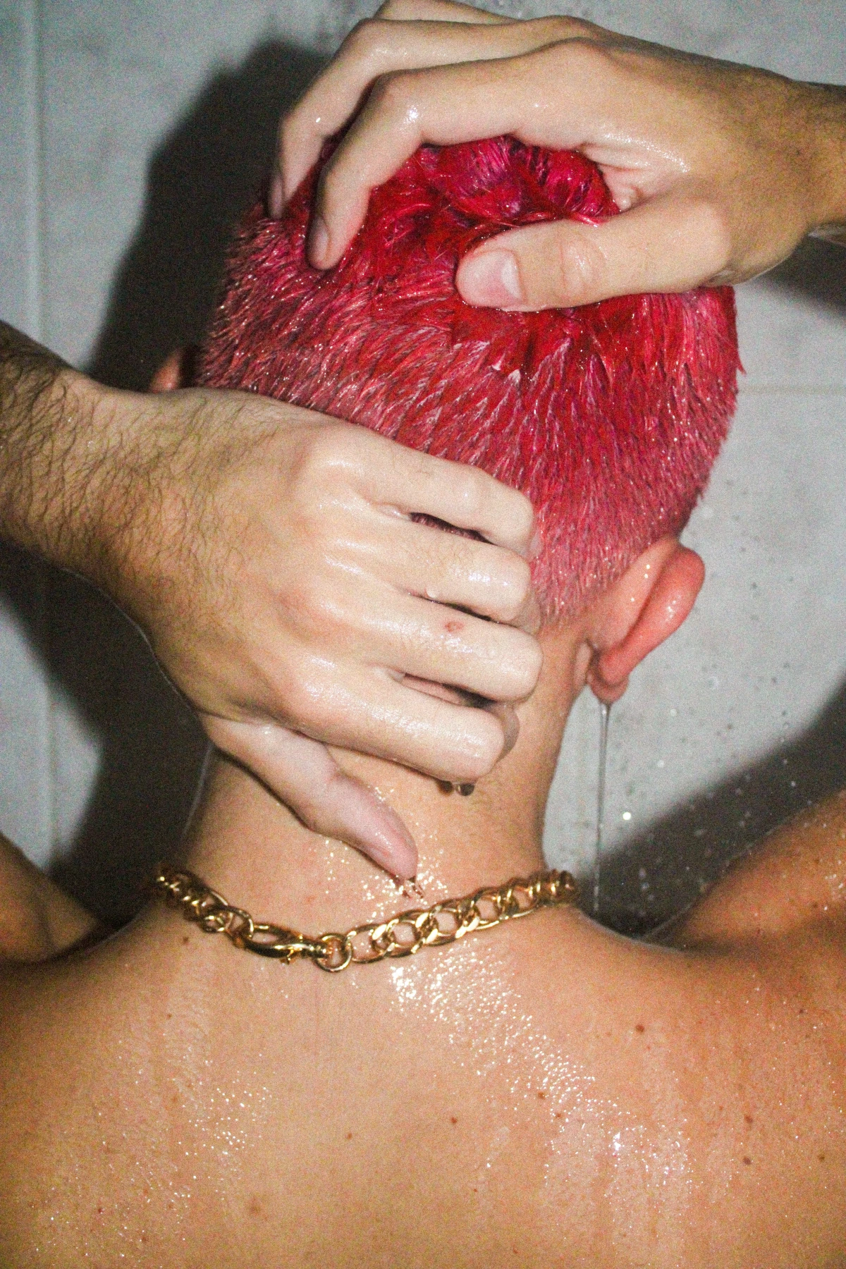 benefits of warm showers man with pink hair showering