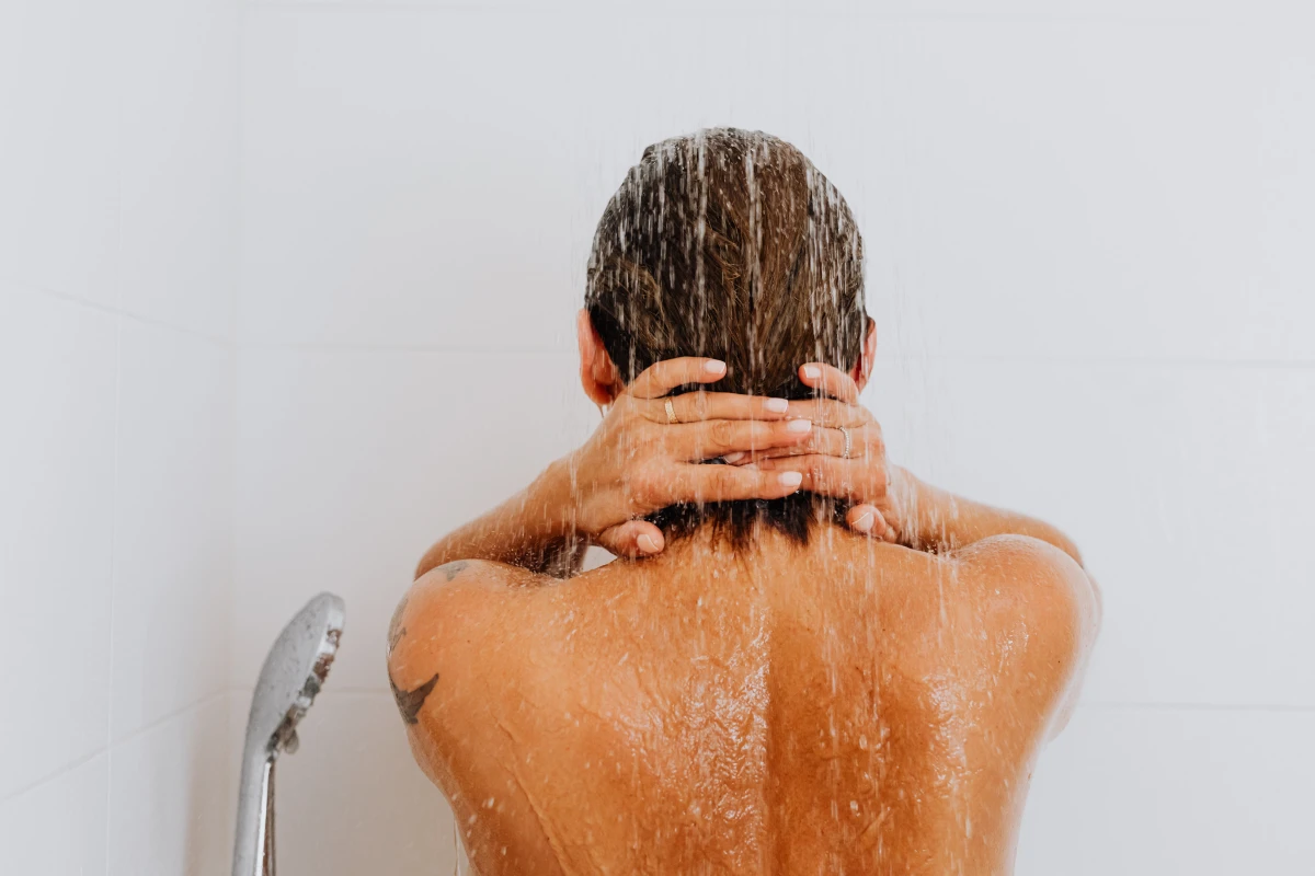 benefits of warm showers person in the shower