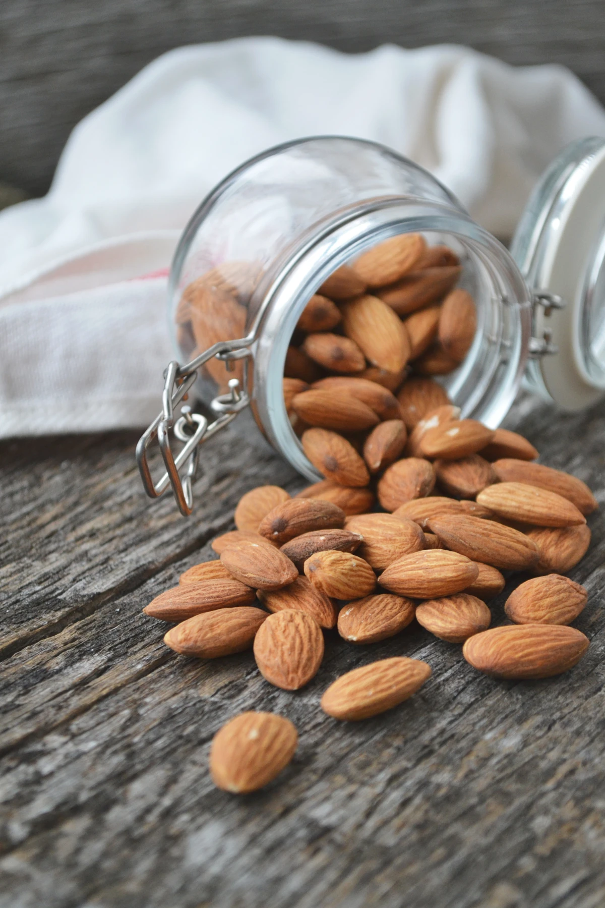 foods that help reduce anxiety almonds spilling from jar