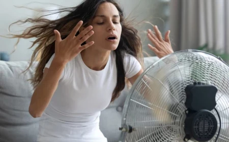 how to cool down a room woman using a fan