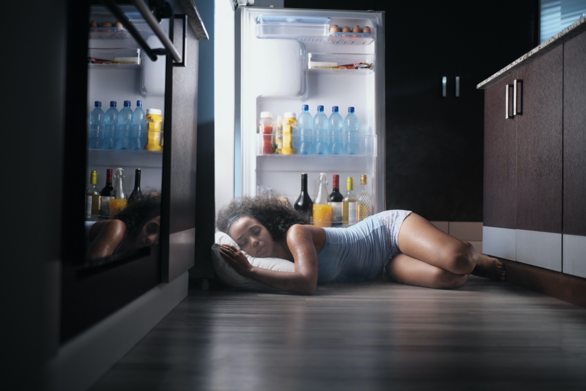 black woman awake for heat wave sleeping in fridge