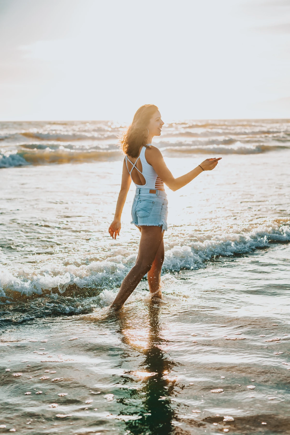 woman walking along beach side