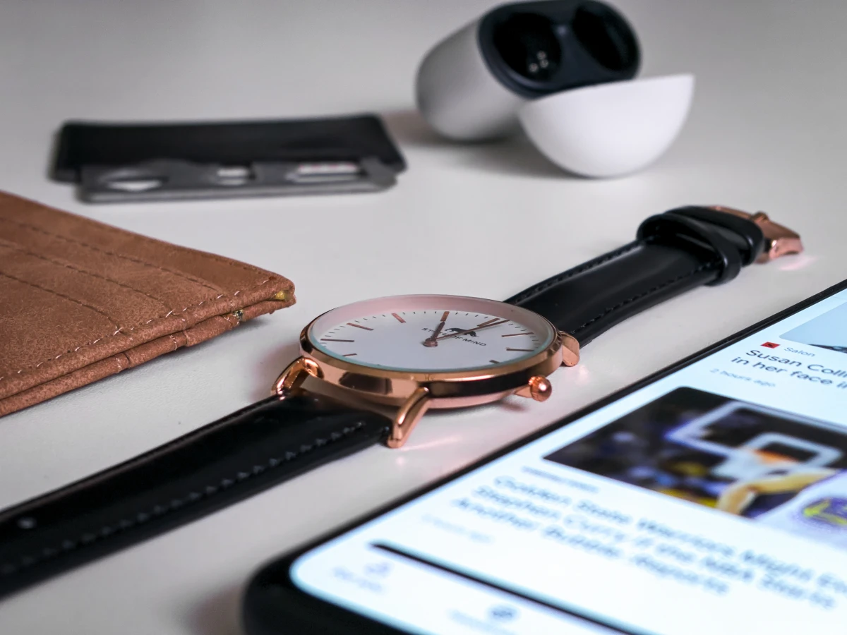 essential accessories watch phone on table