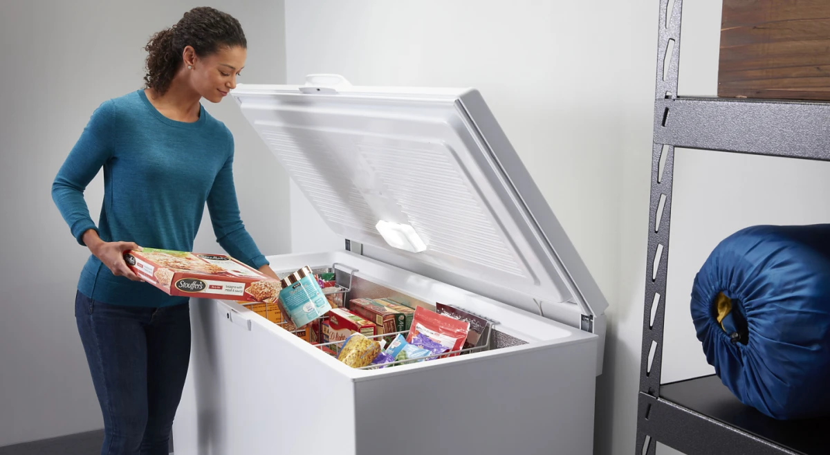 woman putting things in freezer