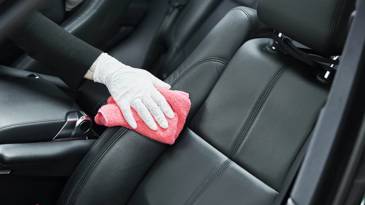 person cleaning car seat