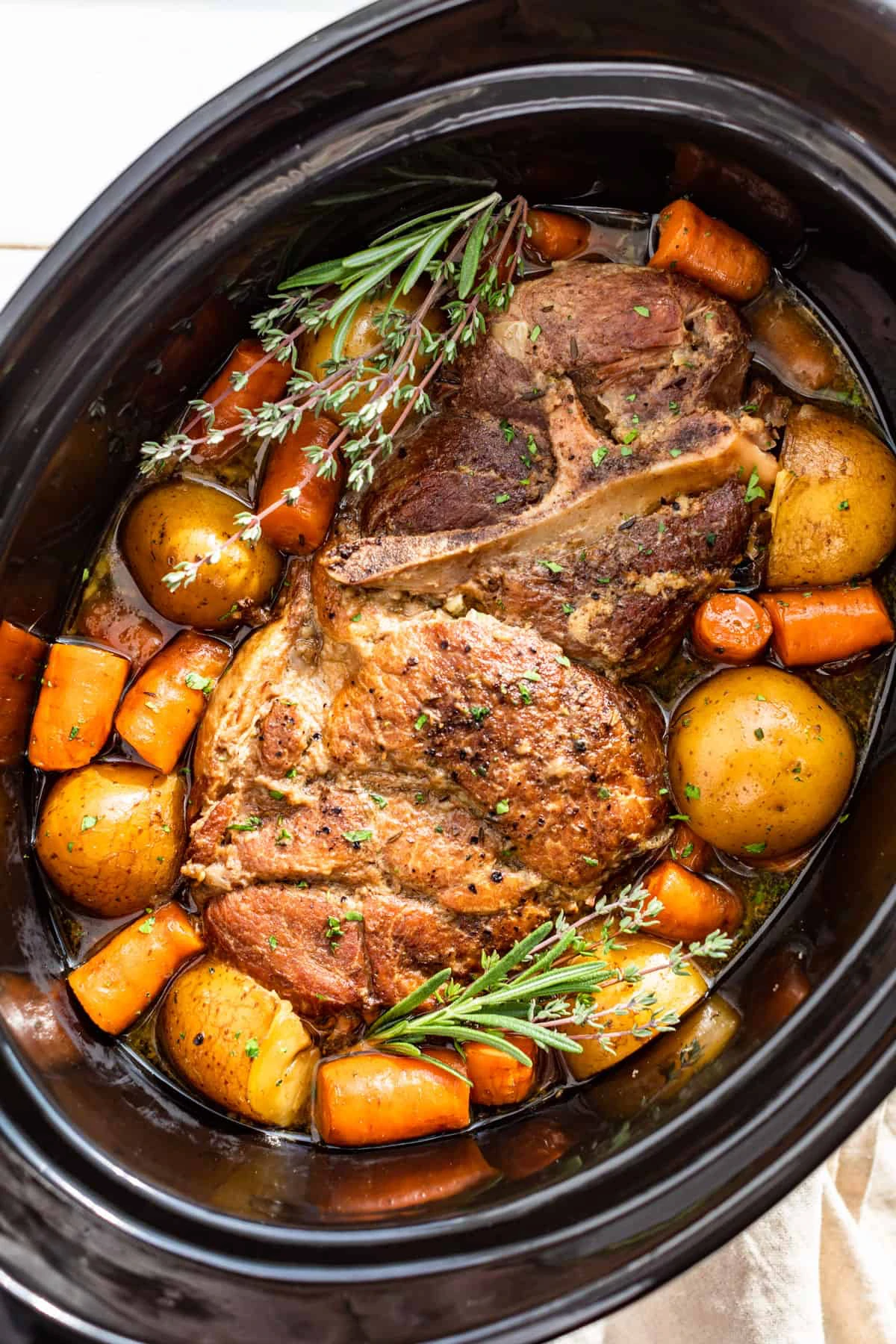 slow cooker with potatoes carrots and meat