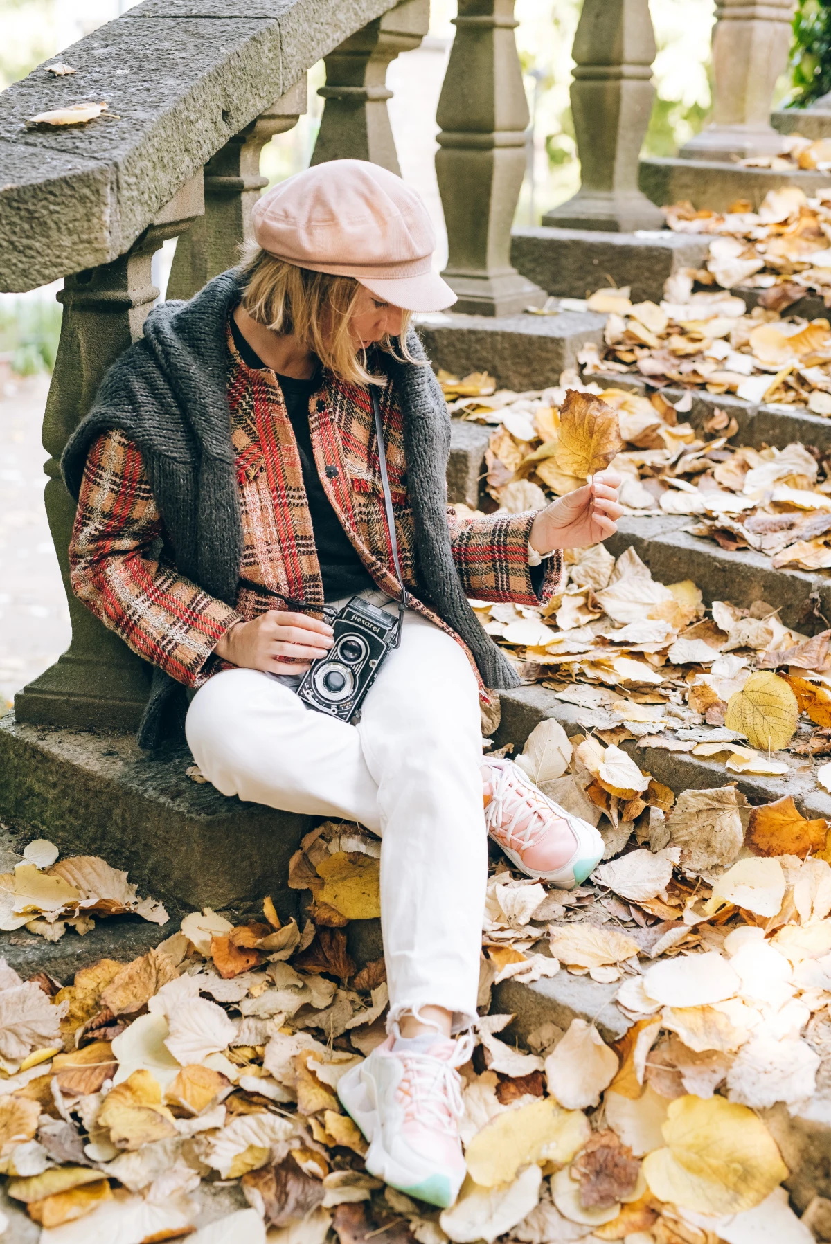 woman sitting on fallen leaves