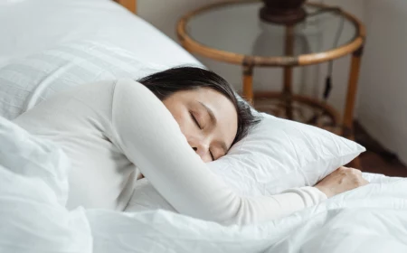 fix your sleep schedule woman sleeping in bed