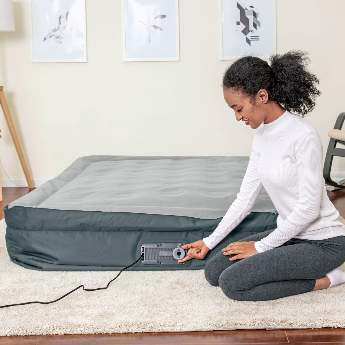 make an air mattress more comfortable woman inflating air mattress