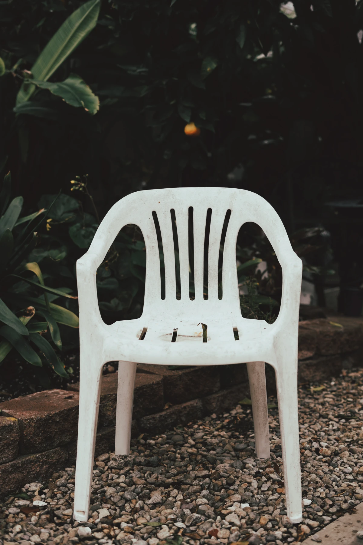 protect garden furniture white plastic chair outside in garden