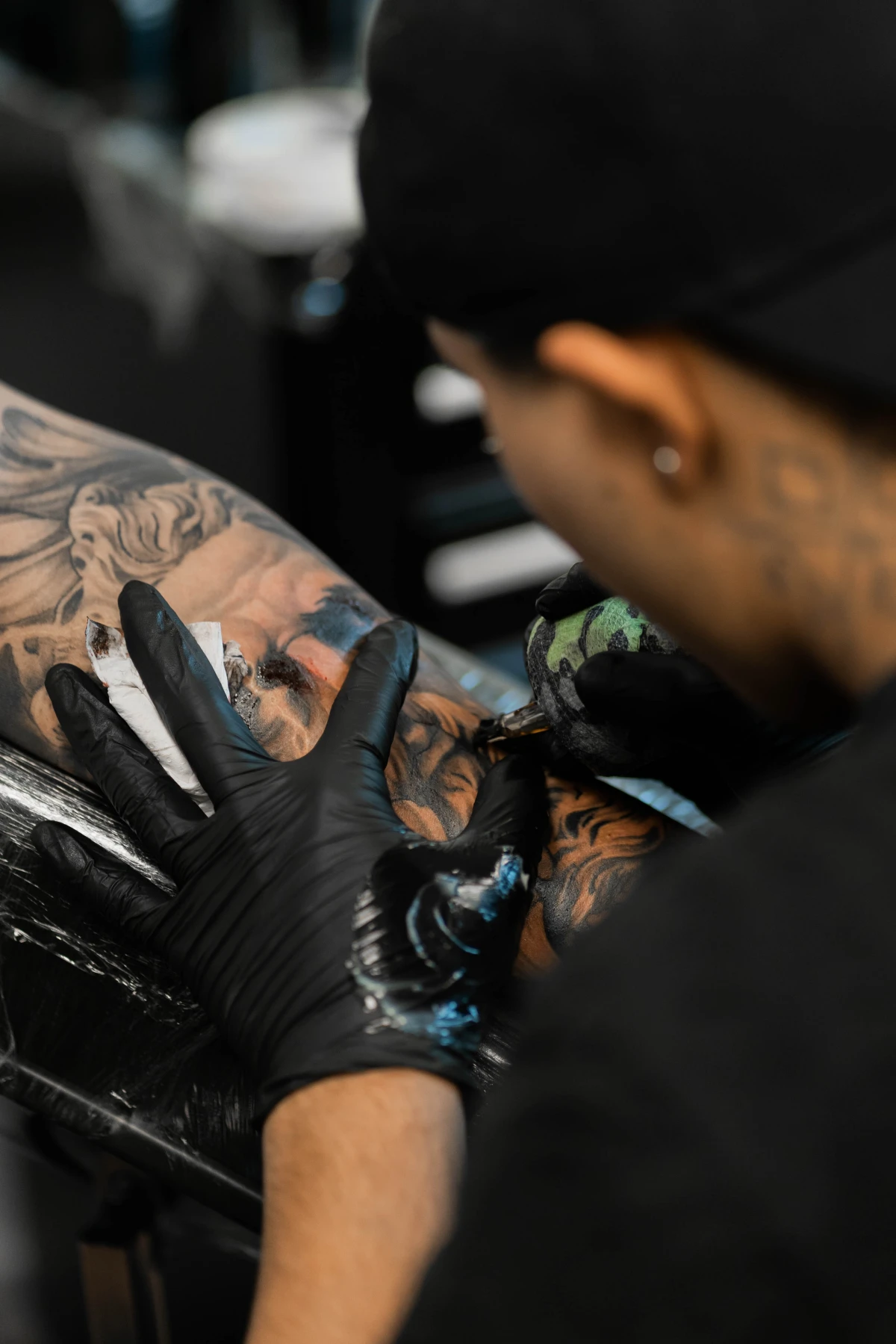 tattoos with hidden meaning man tattooing arm