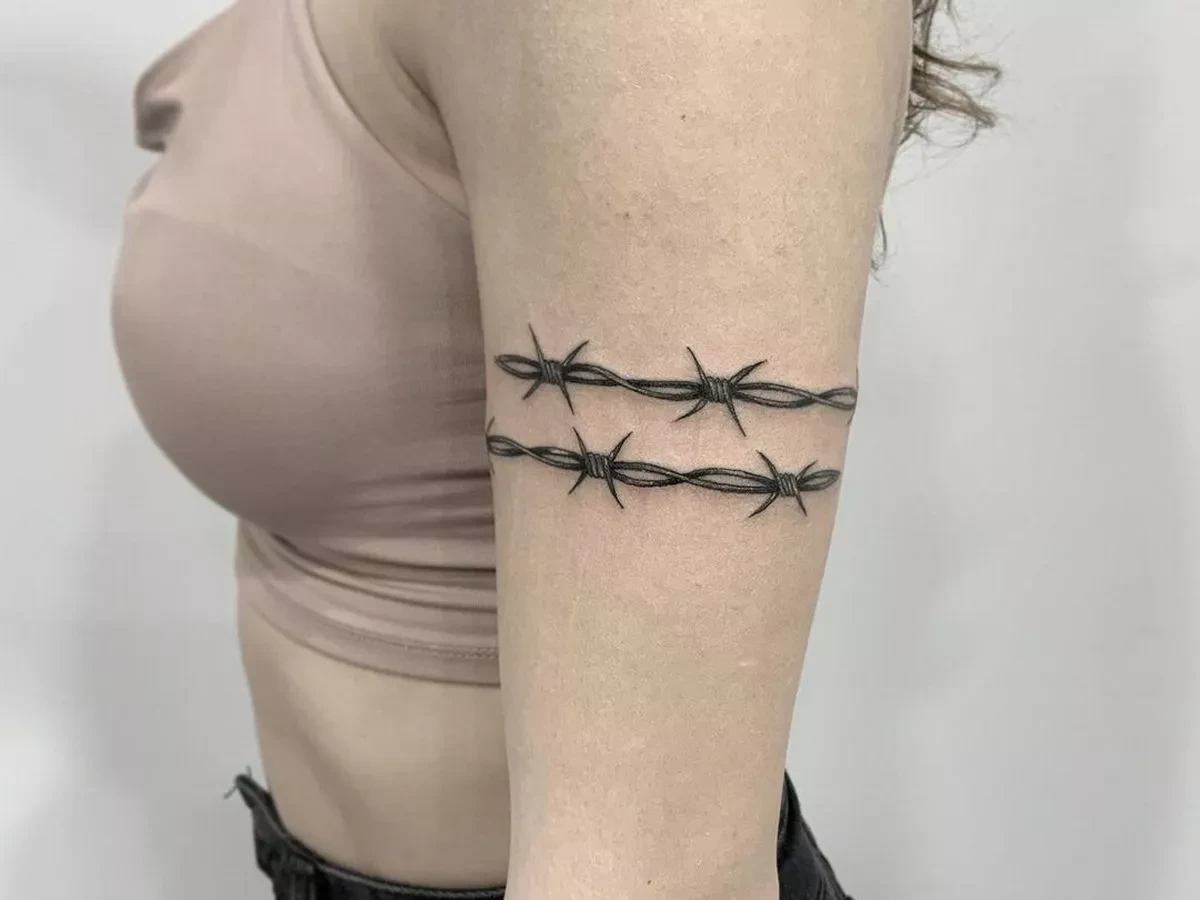 tattoos with hidden meaning woman with barbed wire tattoo