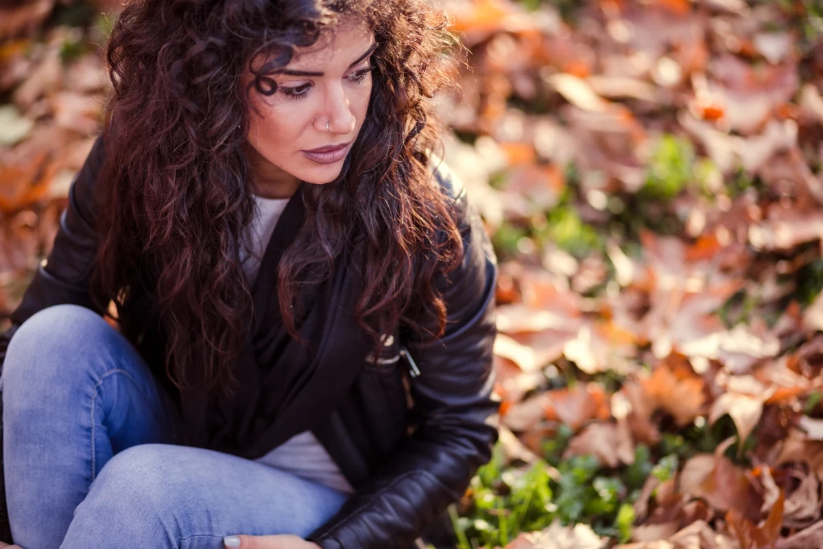 woman with long hair on fall leaves.jpg