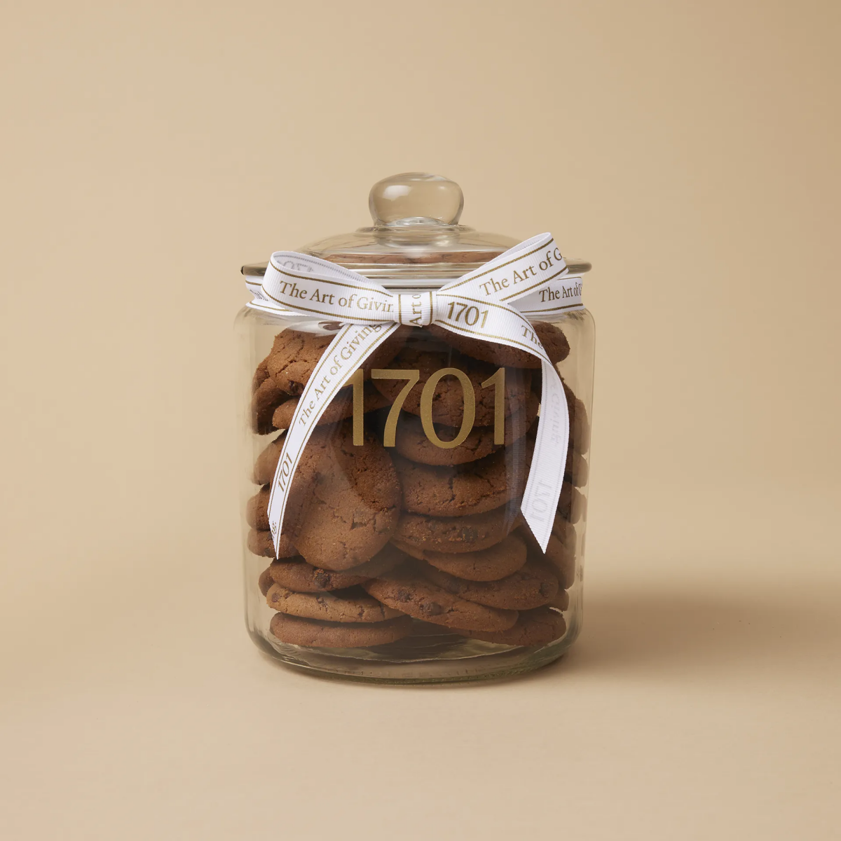christmas cookies in a jar with a white ribbon