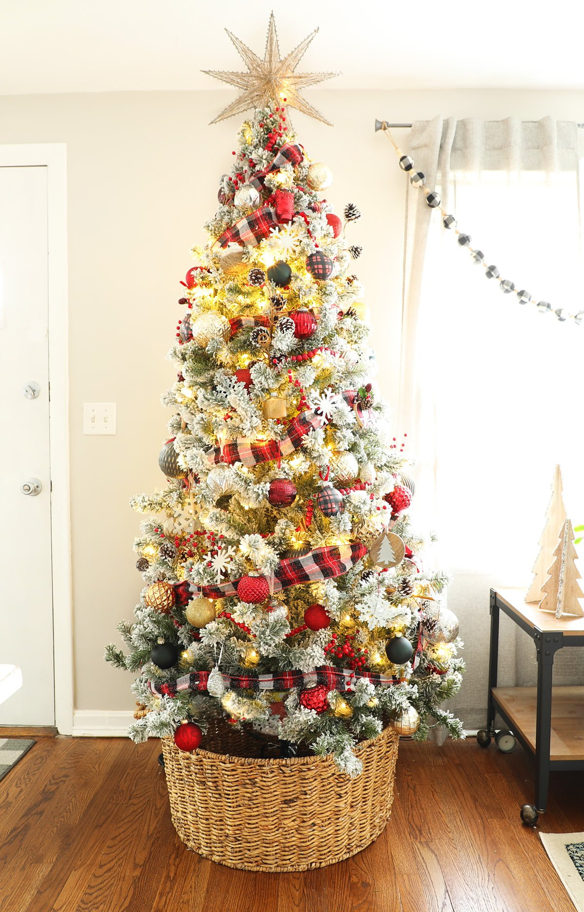 flocked tree with plaid and pine cones