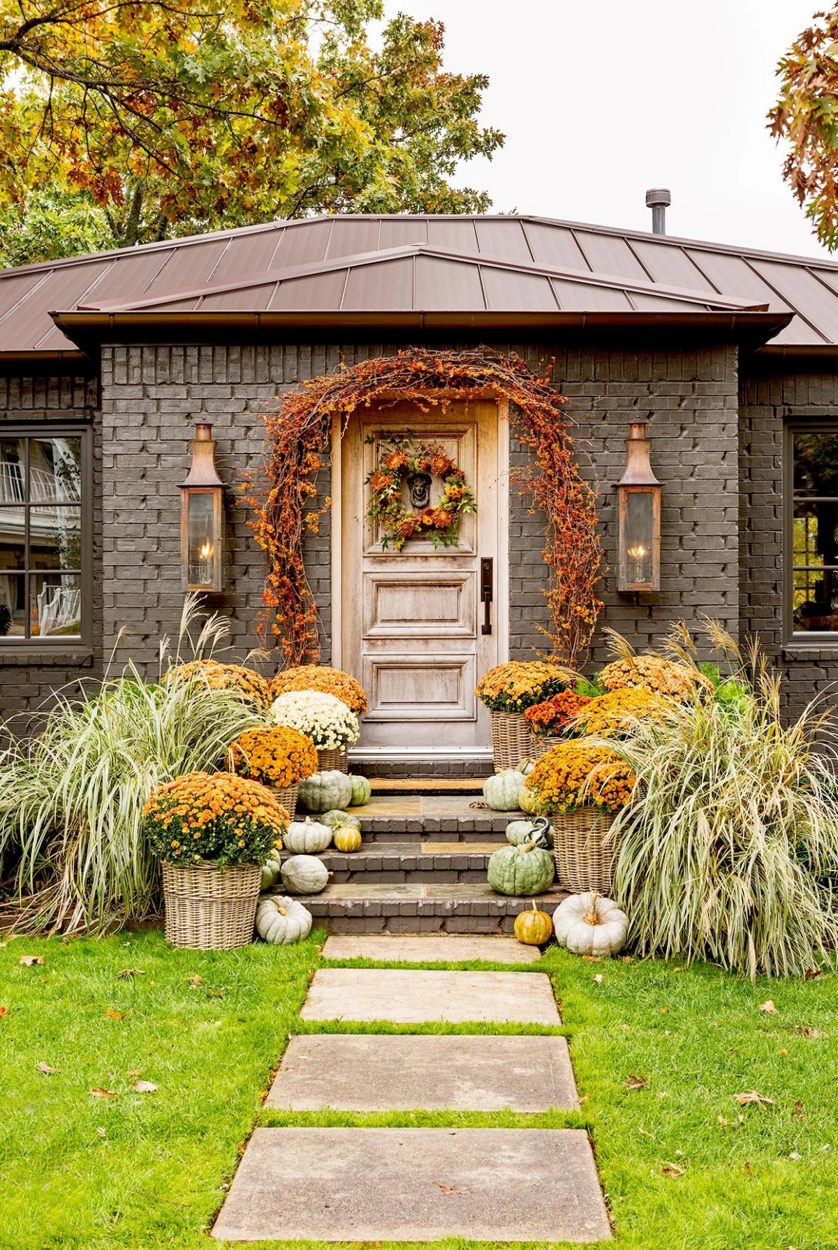 front door with pumpkins plants